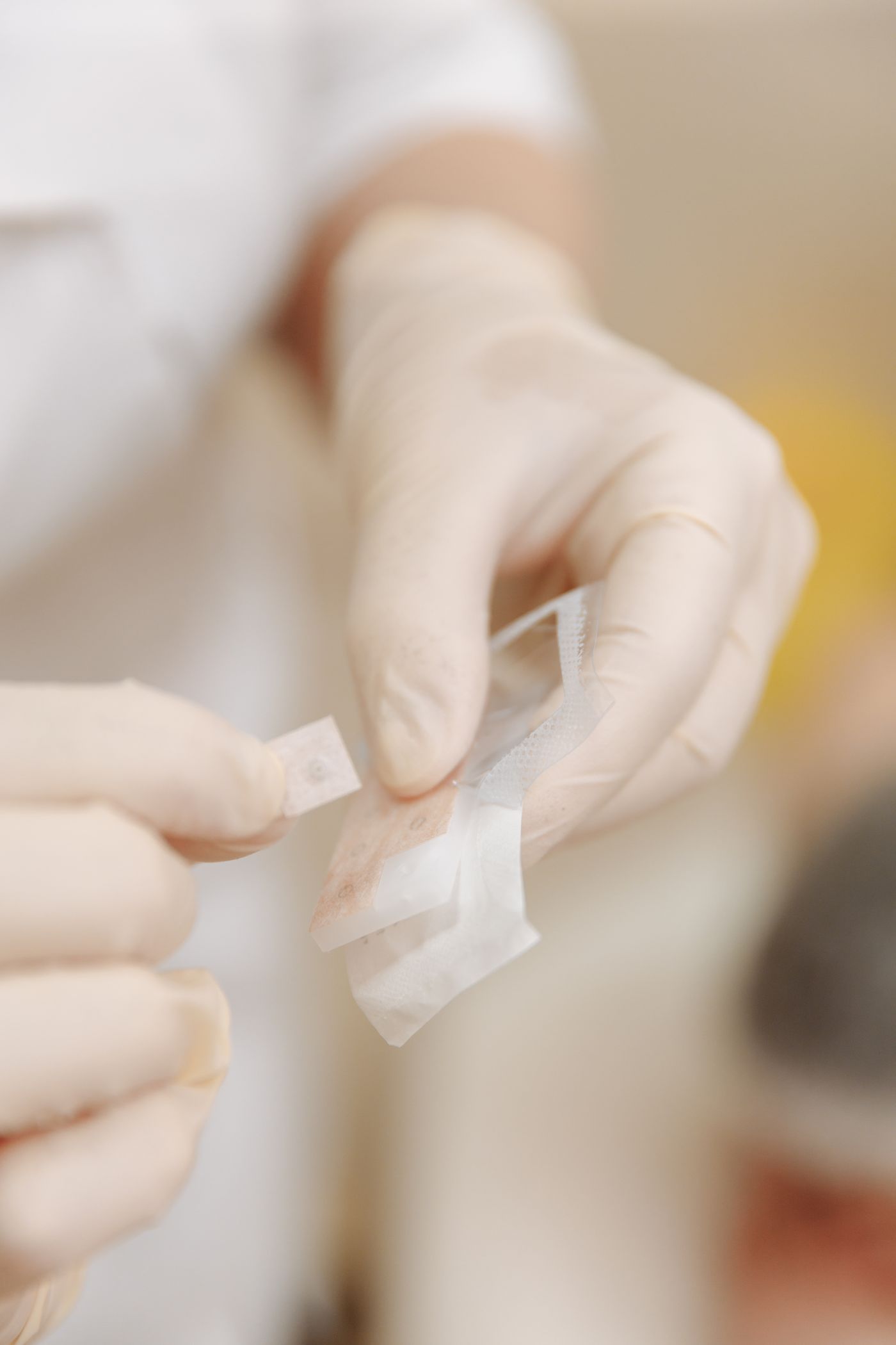 A healthcare professional assisting with wound treatment