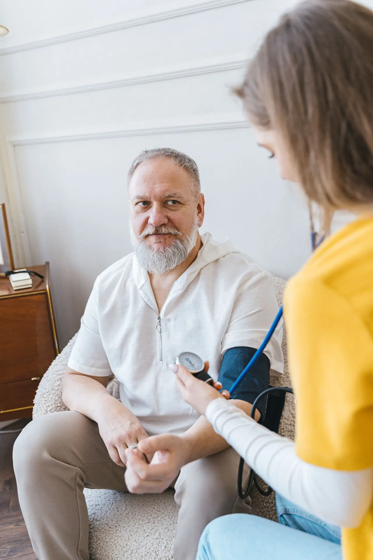 Healthcare worker assisting an older adult at home